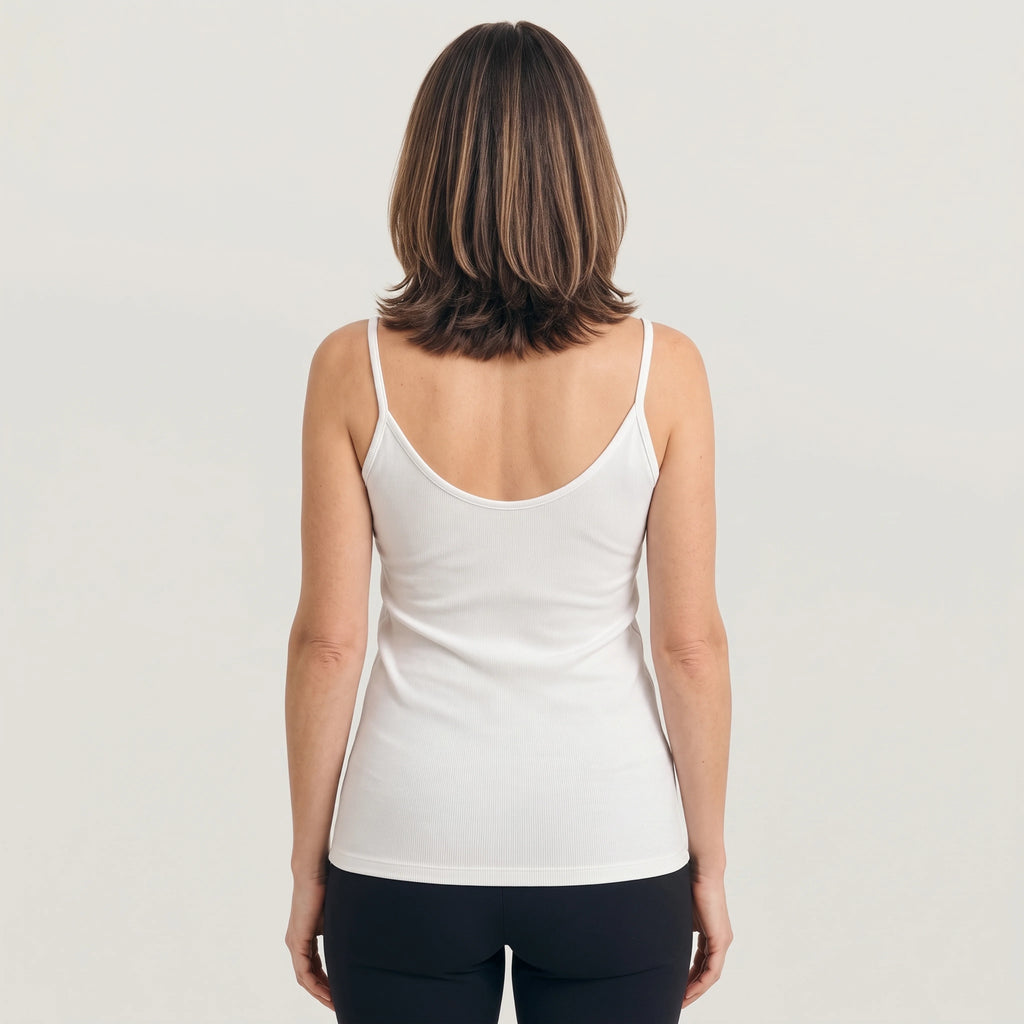 Back view of a white ribbed camisole with a low scoop back and thin straps on a light studio background