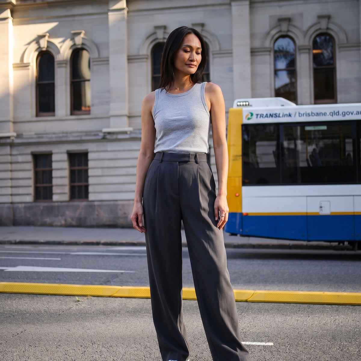 Built-in bra tank top in melange grey, styled with dark grey high-waisted tailored pants