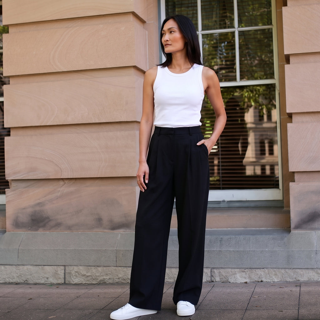 Built-in bra tank top in off white with black wide-leg tailored pants and white sneakers