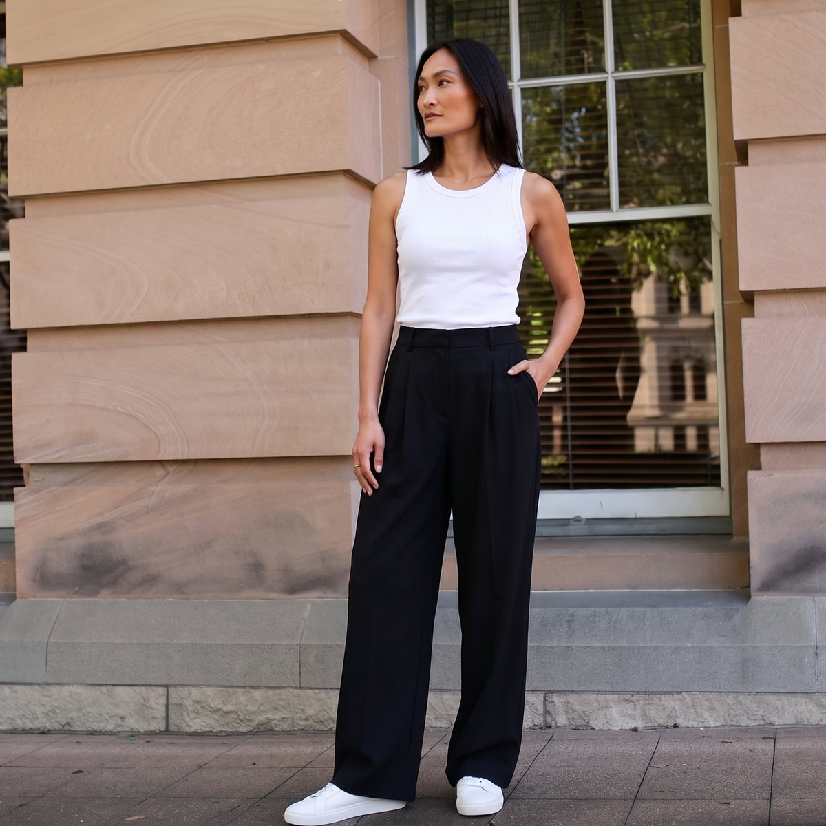 Built-in bra tank top in off white with black wide-leg tailored pants and white sneakers