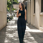 Black built-in bra tank top with black tailored pants, holding a takeaway coffee