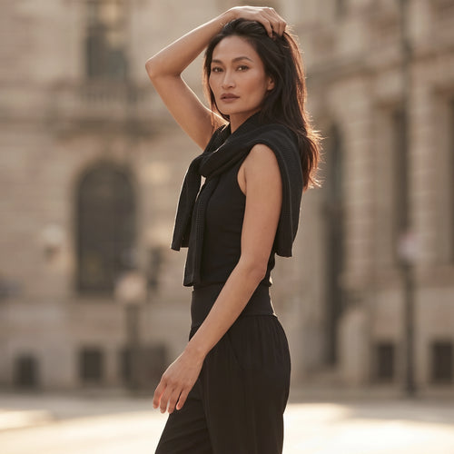 Le monde des hiboux built-in bra tank top in black, styled with a dark knit sweater tied over the shoulders