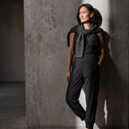 Le monde des hiboux woven jogger pants in black, styled with a sleeveless top and a charcoal knit sweater over the shoulders
