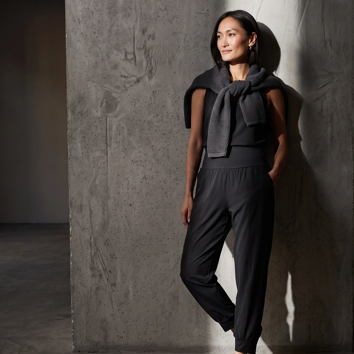 Le monde des hiboux woven jogger pants in black, styled with a sleeveless top and a charcoal knit sweater over the shoulders